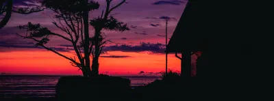 Bright pink orange and purple sunset with trees